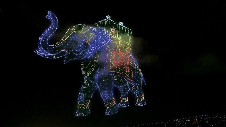 Mysuru Dasara drone show displaying Goddess Chamundeshwari and the golden ambari elephant in the night sky.