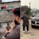 Bangladesh minister Ishraque Hossain holding a megaphone and pistol during a reported raid near a suspected drug den in Dhaka.