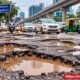 Bengaluru road filled with potholes causing problems for motorists